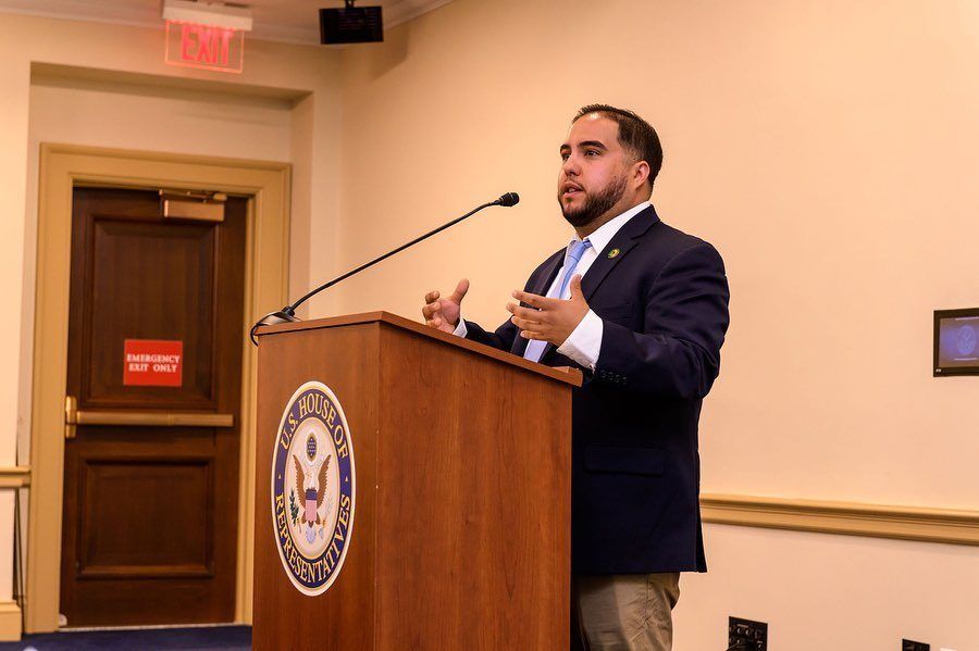 Kaliko Castille speaking at a podium during a congressional briefing